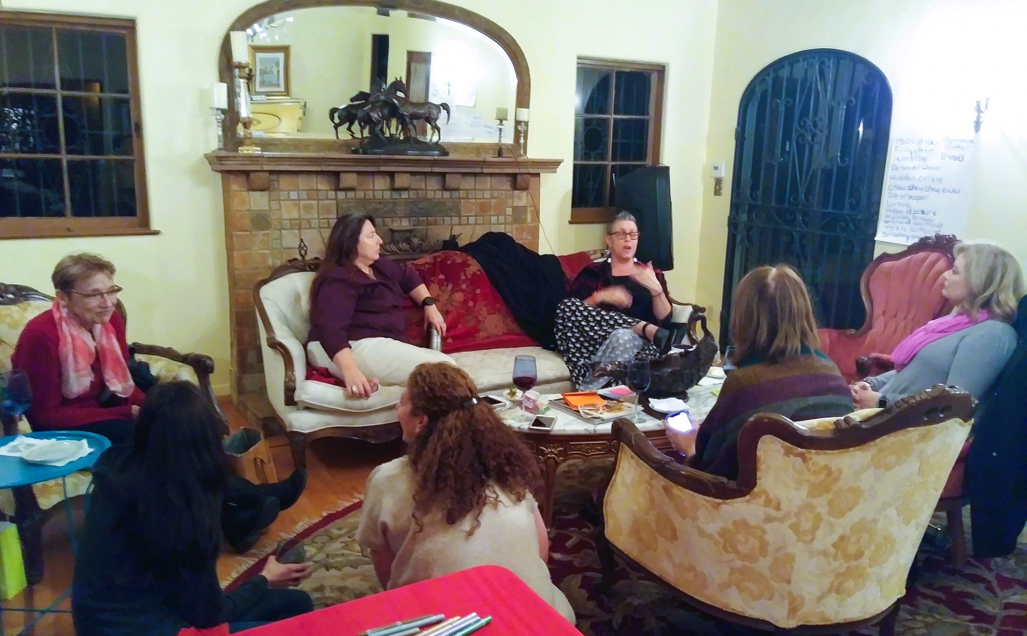 Group of women at Lisa's retreat sitting around talking at Acacia Mansion
